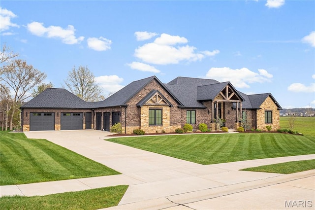 view of front facade with brick siding, driveway, an attached garage, and a front lawn