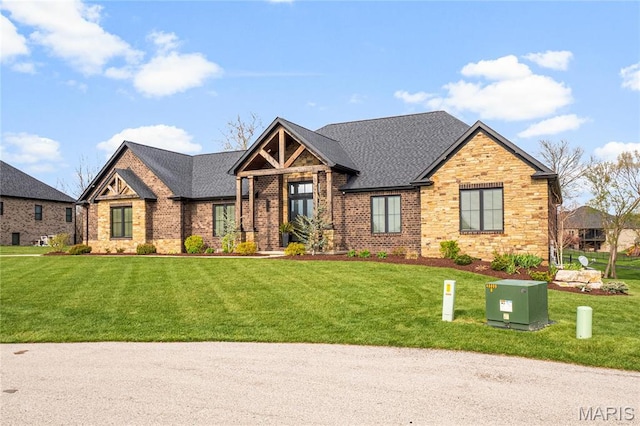 view of front of house featuring a front lawn, brick siding, and a shingled roof