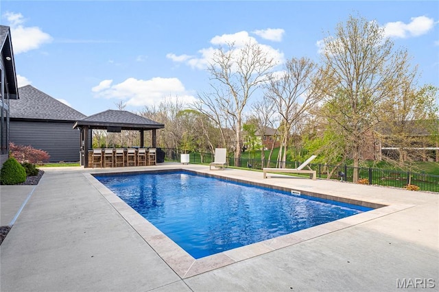view of swimming pool with fence, a patio area, and a gazebo