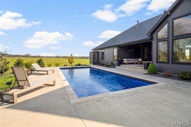 outdoor pool featuring outdoor lounge area and a patio area