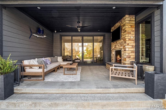 view of patio with an outdoor living space with a fireplace, french doors, and a ceiling fan