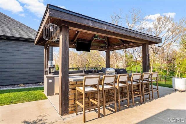 view of patio / terrace featuring area for grilling, a gazebo, and fence