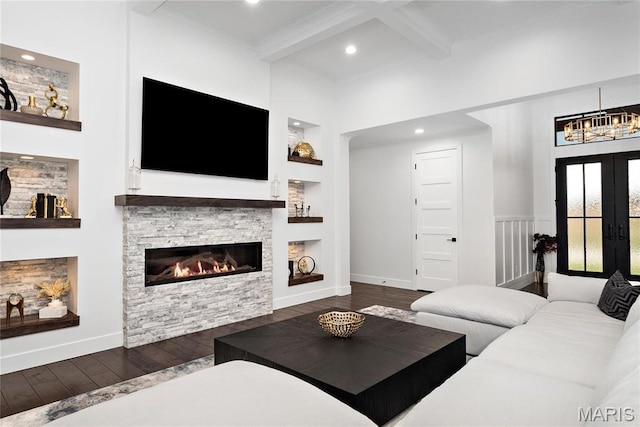living room featuring beam ceiling, hardwood / wood-style floors, a stone fireplace, baseboards, and recessed lighting