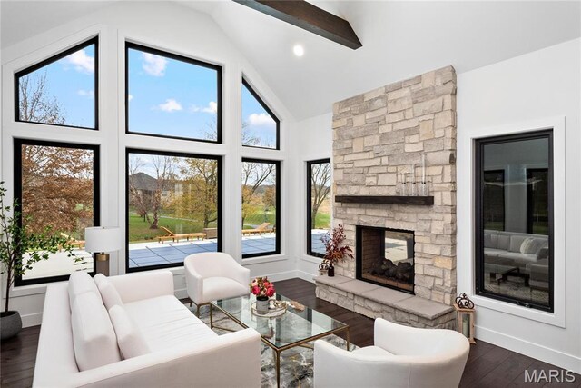 living area with dark wood-style floors, a fireplace, baseboards, and high vaulted ceiling