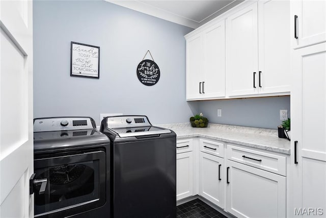 clothes washing area with washer and clothes dryer and cabinet space