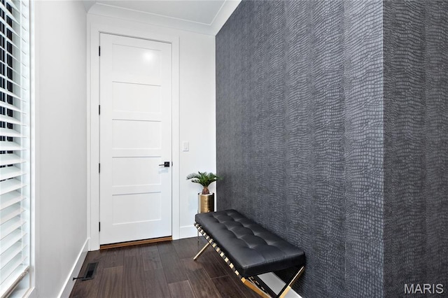 doorway with dark wood-type flooring and baseboards
