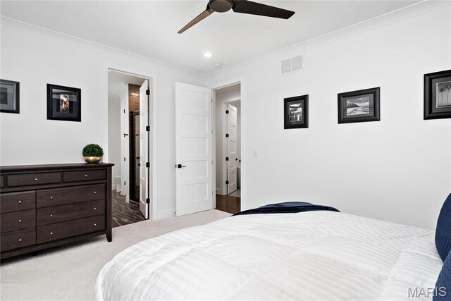 bedroom featuring light colored carpet, crown molding, a ceiling fan, and baseboards