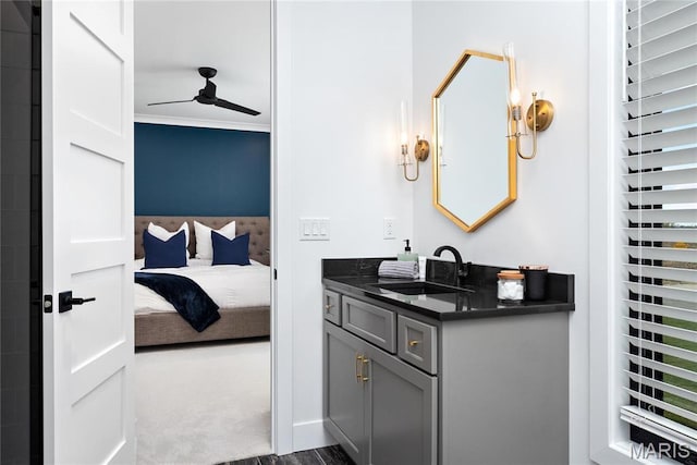 ensuite bathroom featuring a ceiling fan and vanity
