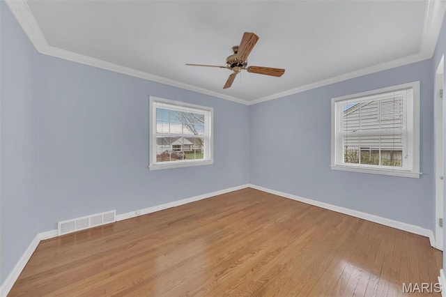 unfurnished room with wood finished floors, ceiling fan, baseboards, and ornamental molding