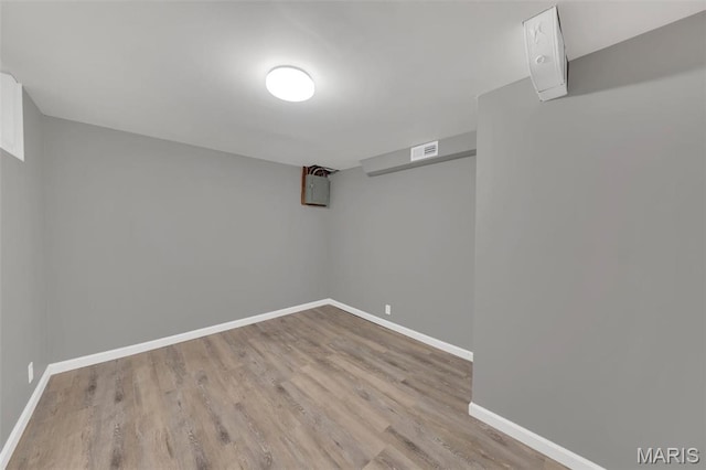 finished below grade area with wood finished floors and baseboards