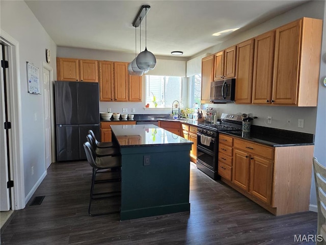 6029 Timber Hollow Ln, High Ridge, MO 63049 - kitchen with stainless steel appliances, a center island, dark wood-style floors, and decorative light fixtures