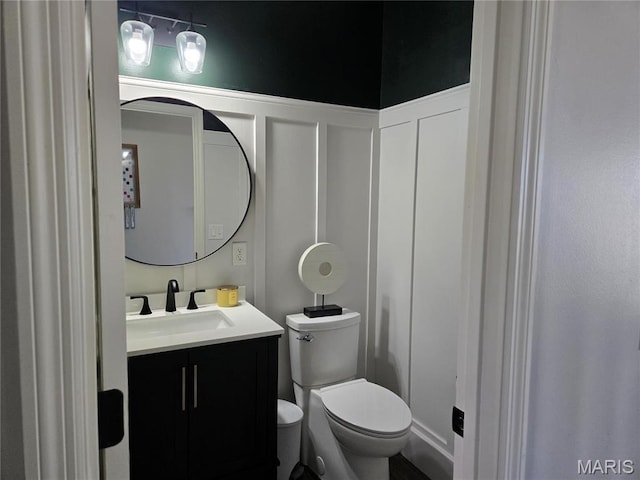 6029 Timber Hollow Ln, High Ridge, MO 63049 - bathroom featuring a decorative wall, toilet, vanity, and a wainscoted wall