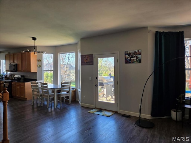 6029 Timber Hollow Ln, High Ridge, MO 63049 - dining room featuring dark wood-type flooring, a chandelier, baseboards, and plenty of natural light