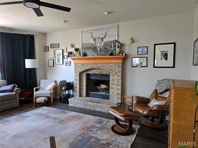 6029 Timber Hollow Ln, High Ridge, MO 63049 - living area with wood finished floors, a ceiling fan, and a brick fireplace