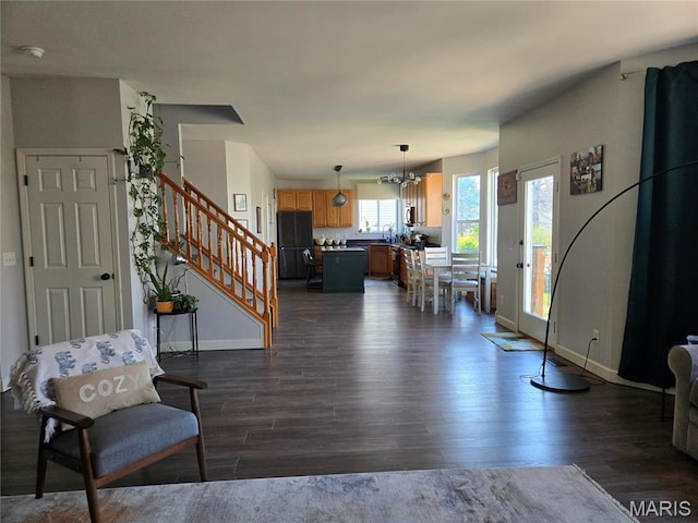 6029 Timber Hollow Ln, High Ridge, MO 63049 - living area featuring dark wood finished floors, stairs, baseboards, and a chandelier