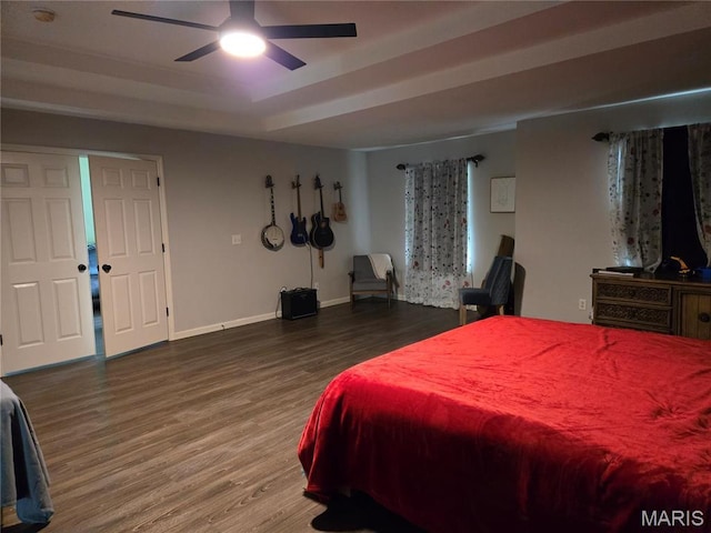 6029 Timber Hollow Ln, High Ridge, MO 63049 - bedroom featuring wood finished floors, baseboards, a raised ceiling, and a ceiling fan