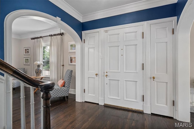 582 S Berry Rd, Webster Groves, MO 63122 - entrance foyer with arched walkways, dark wood-style flooring, ornamental molding, and baseboards