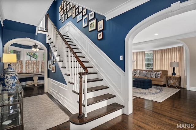582 S Berry Rd, Webster Groves, MO 63122 - stairway with arched walkways, ceiling fan, wood finished floors, wainscoting, and a decorative wall