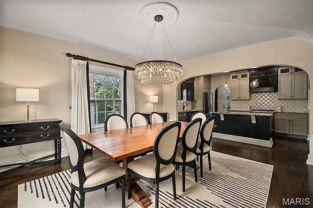 582 S Berry Rd, Webster Groves, MO 63122 - dining room featuring a chandelier, dark wood-type flooring, arched walkways, and vaulted ceiling