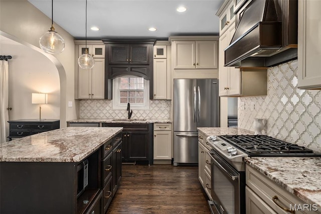 582 S Berry Rd, Webster Groves, MO 63122 - kitchen featuring stainless steel appliances, custom exhaust hood, a sink, decorative backsplash, and decorative light fixtures