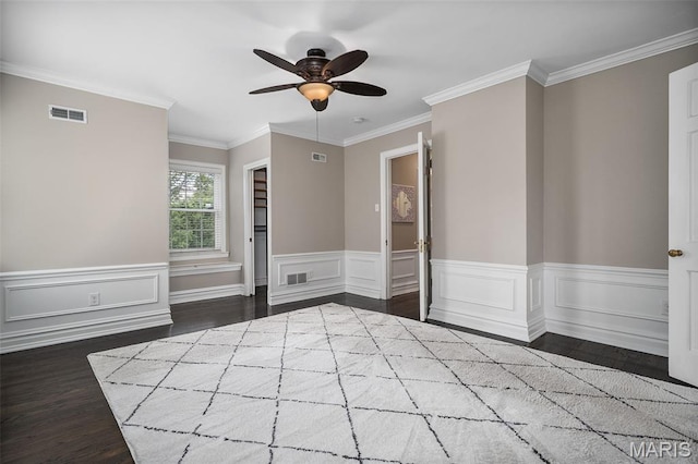 582 S Berry Rd, Webster Groves, MO 63122 - unfurnished bedroom featuring dark wood-style flooring, a wainscoted wall, crown molding, and ceiling fan