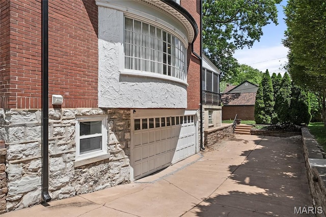 582 S Berry Rd, Webster Groves, MO 63122 - view of property exterior with stone siding, brick siding, and a garage