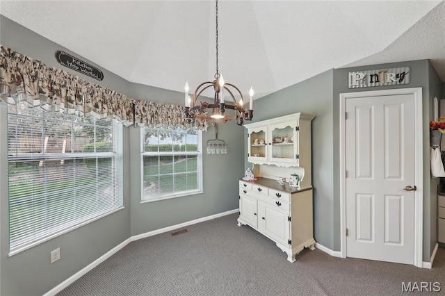 1001 Hawthorne Pl, Ofallon, IL 62269 - unfurnished dining area with dark colored carpet, a chandelier, vaulted ceiling, and baseboards