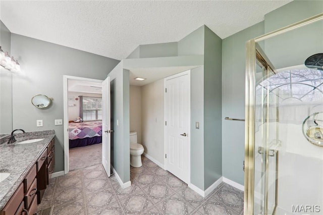 1001 Hawthorne Pl, Ofallon, IL 62269 - ensuite bathroom featuring toilet, a shower stall, double vanity, a textured ceiling, and baseboards