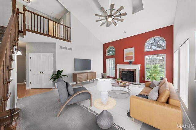 1001 Hawthorne Pl, Ofallon, IL 62269 - living room featuring high vaulted ceiling, a ceiling fan, a fireplace, and healthy amount of natural light