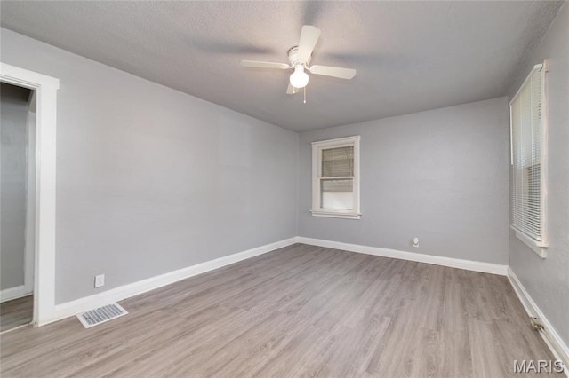 811 Marvin Ave, Saint Louis, MO 63135 - empty room with wood finished floors, a ceiling fan, and baseboards