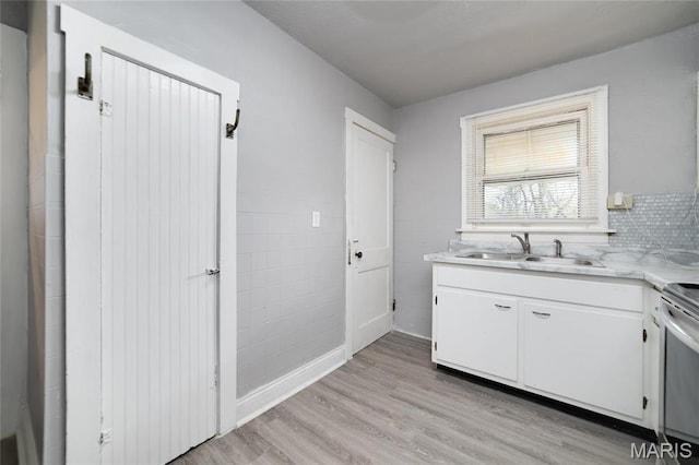 811 Marvin Ave, Saint Louis, MO 63135 - kitchen with a sink, light countertops, stainless steel range with electric stovetop, and light wood finished floors