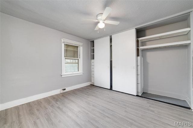 811 Marvin Ave, Saint Louis, MO 63135 - unfurnished bedroom with wood finished floors, baseboards, a textured ceiling, and a ceiling fan