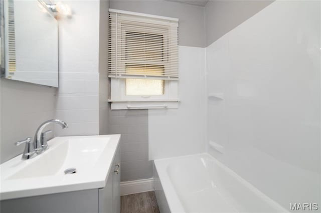 811 Marvin Ave, Saint Louis, MO 63135 - bathroom with vanity, wood finished floors, bathing tub / shower combination, and baseboards