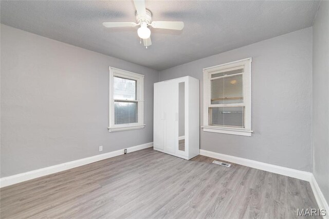 811 Marvin Ave, Saint Louis, MO 63135 - unfurnished bedroom with wood finished floors, baseboards, and a ceiling fan