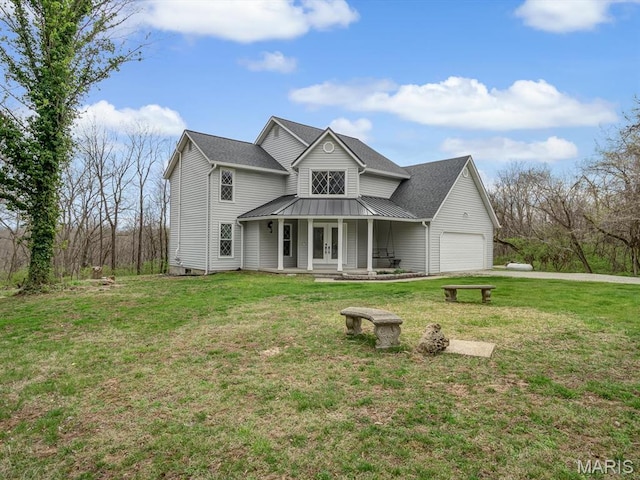 7506 D Rd, Waterloo, IL 62298 - view of front of house featuring french doors, an attached garage, a front lawn, driveway, and metal roof