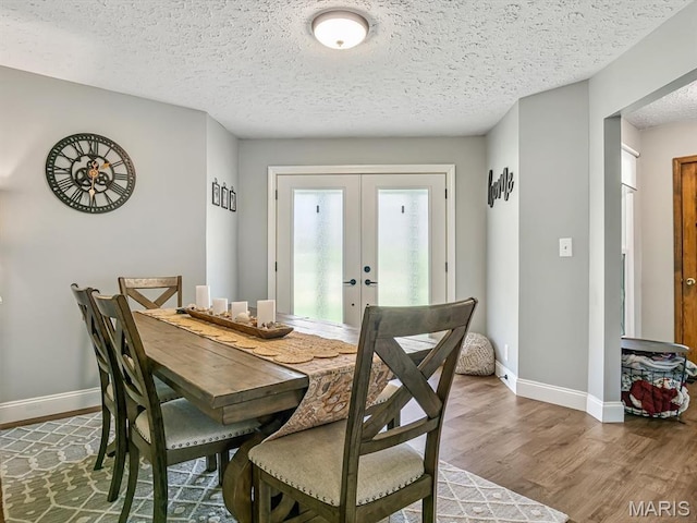 7506 D Rd, Waterloo, IL 62298 - dining room with wood finished floors, baseboards, french doors, and a textured ceiling