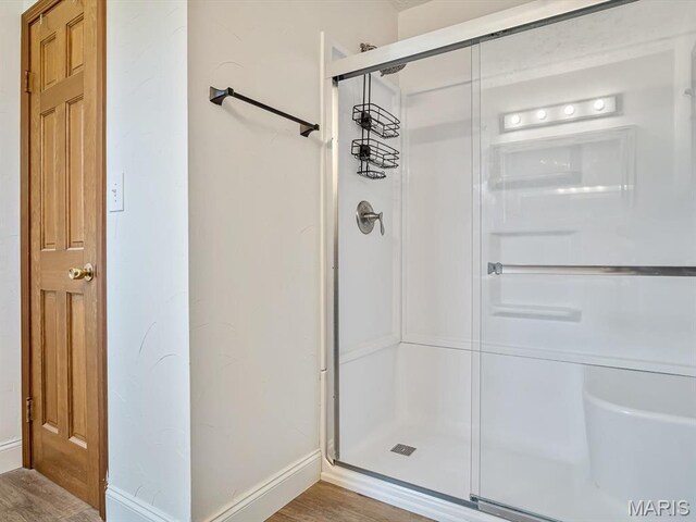 7506 D Rd, Waterloo, IL 62298 - bathroom featuring a shower stall, wood finished floors, and baseboards