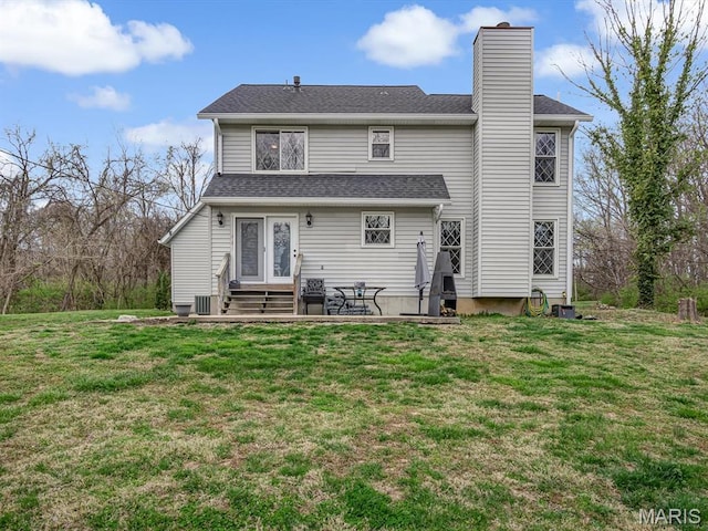 7506 D Rd, Waterloo, IL 62298 - rear view of house with entry steps, a chimney, and a yard