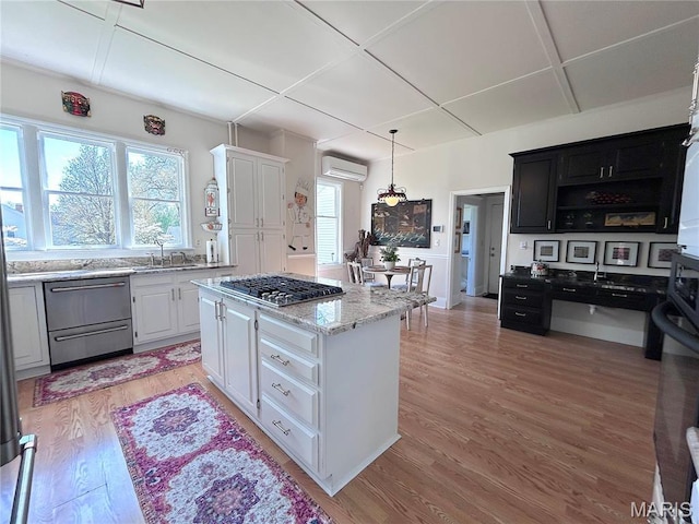 445 E 12th St, Alton, IL 62002 - kitchen with appliances with stainless steel finishes, a wall unit AC, plenty of natural light, and light wood-style floors