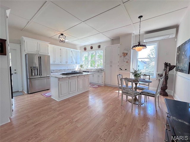 445 E 12th St, Alton, IL 62002 - kitchen featuring appliances with stainless steel finishes, an AC wall unit, white cabinetry, and a sink