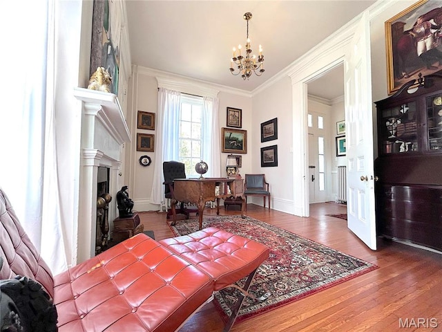 445 E 12th St, Alton, IL 62002 - home office featuring a chandelier, wood finished floors, a fireplace with raised hearth, crown molding, and baseboards