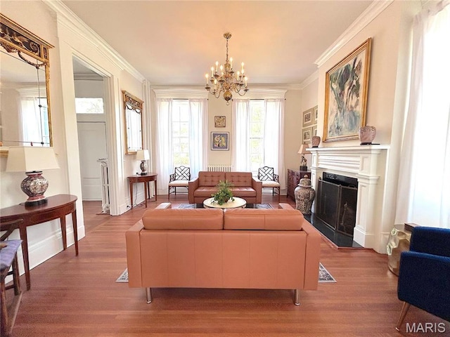 445 E 12th St, Alton, IL 62002 - living room featuring wood finished floors, a chandelier, ornamental molding, and a fireplace with flush hearth