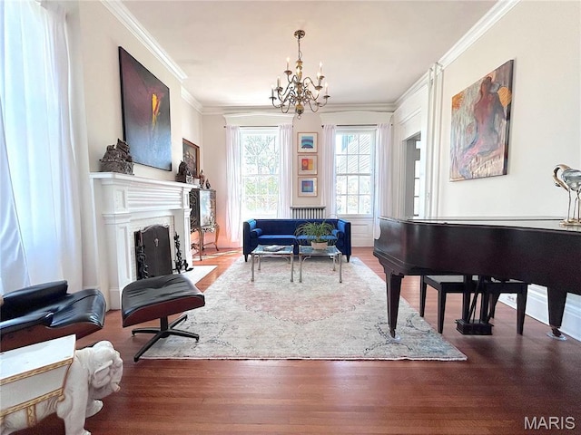 445 E 12th St, Alton, IL 62002 - living area with crown molding, a chandelier, wood finished floors, and a fireplace with flush hearth