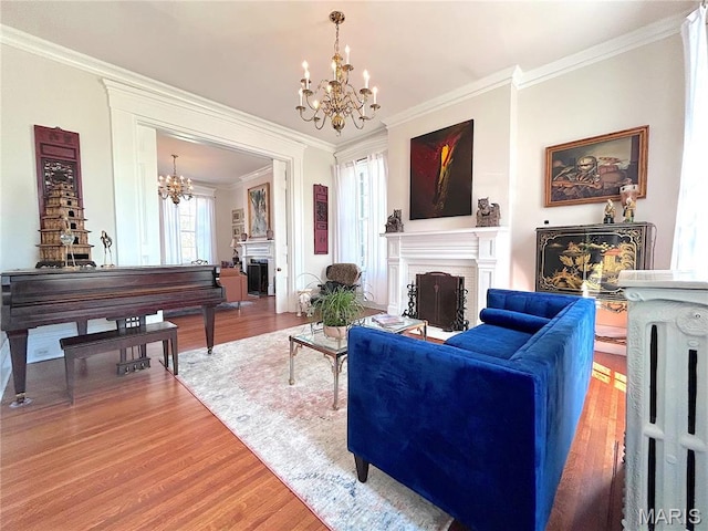 445 E 12th St, Alton, IL 62002 - living area with a fireplace, a chandelier, crown molding, and wood finished floors