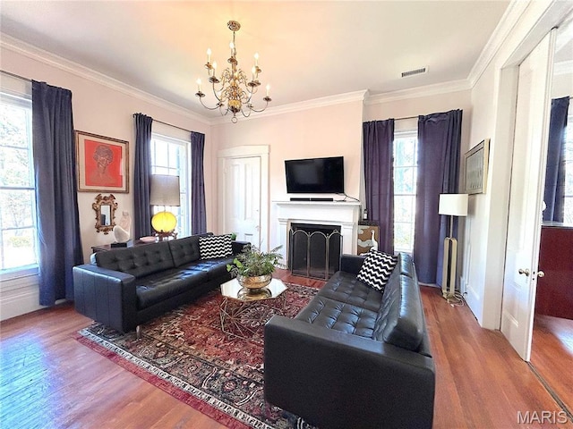 445 E 12th St, Alton, IL 62002 - living area featuring wood finished floors, a chandelier, healthy amount of natural light, and ornamental molding