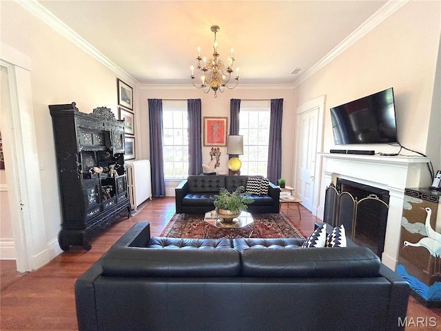 445 E 12th St, Alton, IL 62002 - living area with a chandelier, a fireplace, wood finished floors, ornamental molding, and radiator