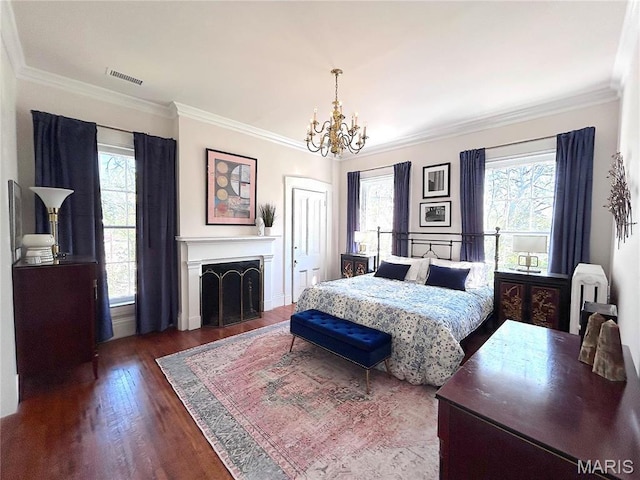 445 E 12th St, Alton, IL 62002 - bedroom with wood finished floors, a chandelier, crown molding, a fireplace, and radiator