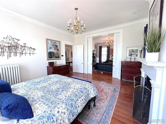 445 E 12th St, Alton, IL 62002 - bedroom featuring radiator heating unit, a chandelier, ornamental molding, wood finished floors, and a fireplace