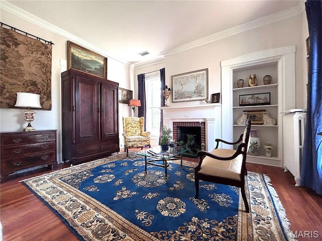 445 E 12th St, Alton, IL 62002 - sitting room with wood finished floors, ornamental molding, built in features, and a fireplace