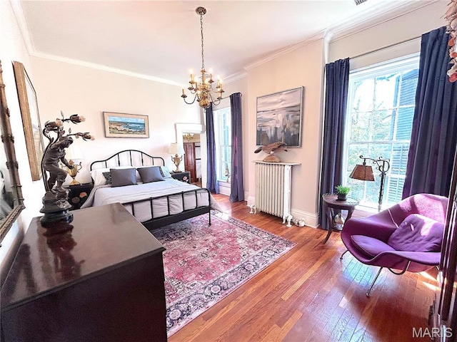 445 E 12th St, Alton, IL 62002 - bedroom with radiator, a chandelier, wood finished floors, crown molding, and baseboards
